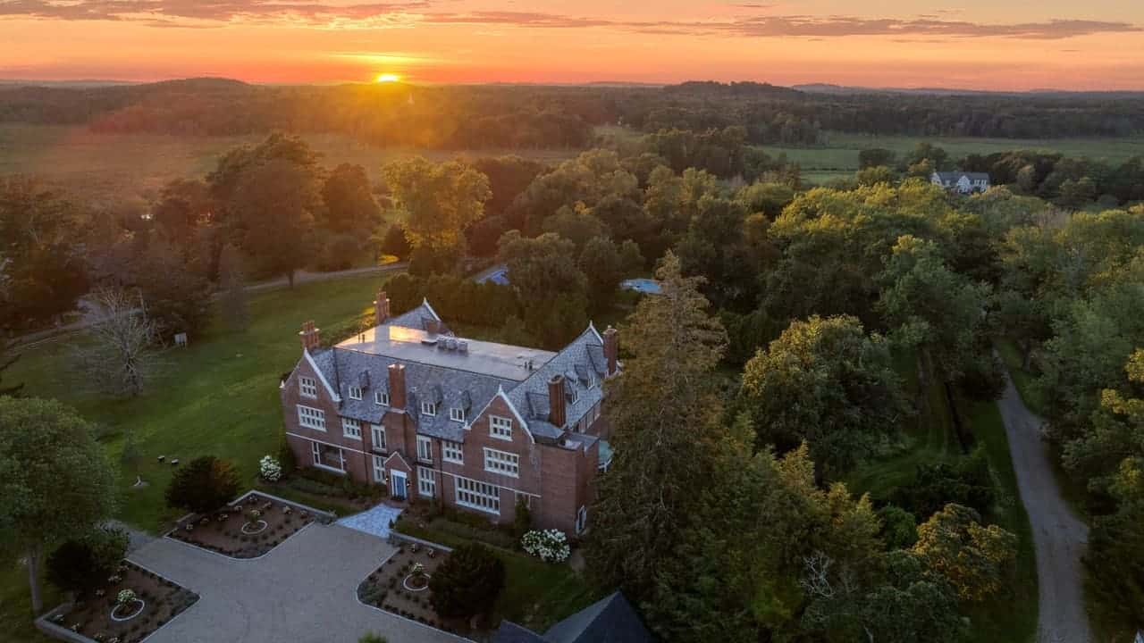 Sunset aerial of a brick estate in Hamilton, Massachusetts